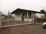 &raquo;The entrance / main gate. You'll arrive here. Mainhall is behind that security building.&laquo; by 